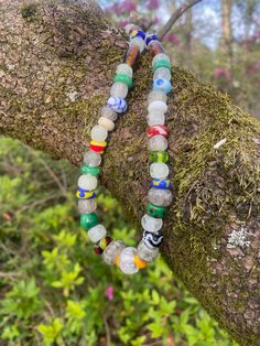 This 17.25 inch necklace is made with lampwork beads in the Norse style. The beads are made of COE 104 glass and the patterns on the beads are based on beads from the Norse and Anglo Saxon world. The glow beads are made with glow powder and give off a green, aqua, or blue glow when charged with light. The piece is strung on stainless steel wire and finished with stainless steel findings and a stainless steel lobster claw clasp. Many of the beads are made of COE 104 soft glass.  Green glows the b Hand-strung Recycled Glass Beaded Bracelets, Hand-strung Round Glass Bead Jewelry, Multicolor Recycled Glass Jewelry With Large Beads, Multicolor Recycled Glass Beaded Jewelry, Multicolor Recycled Glass Bead Jewelry, Spiritual Glass Beaded Necklaces With Oval Beads, Spiritual Glass Beaded Necklaces With Polished Beads, Hand-strung Glass Bead Jewelry, Spiritual Glass Beaded Necklace With Polished Beads