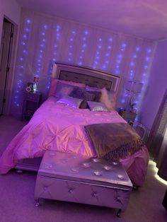 a bedroom with purple lights on the walls