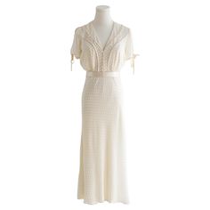 Introducing a one-of-a-kind dress crafted by the House of Chanel for the movie Café Society, starring Kristen Stewart! This exquisite piece is a meticulous recreation from the 1920s Chanel archives, embodying the timeless elegance of that era. The dress features luxurious off-white dotted silk, complemented by a sophisticated satin belt. A delicate lace-trimmed collar and sparkling crystal buttons add to its vintage charm, making it a true masterpiece of haute couture. Comes with COA. In good co 1920s Chanel, Chanel Haute Couture Details, Vintage Chanel Dress, Cafe Society, Satin Belt, Chanel Dress, Off White Dresses, Chanel Haute Couture, Crystal Buttons