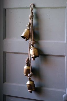 several bells hanging from a rope on a door