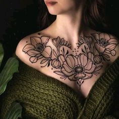 a woman's chest with flowers on it and the top part of her body