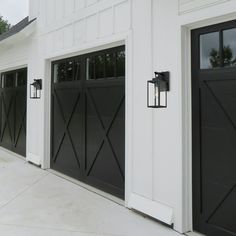 two black and white garage doors with windows