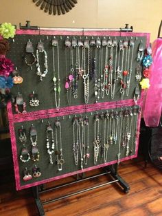 a jewelry rack with many necklaces hanging on it