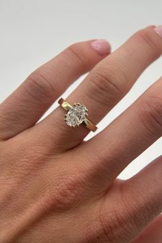 a woman's hand with a diamond ring on it