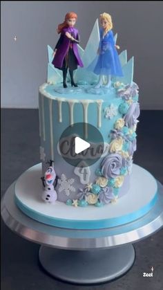 a frozen princess cake with two figures on top