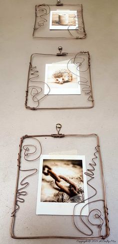 two metal frames with pictures on them and some wire work in the shape of letters