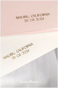 two white and pink envelopes with gold foil on them