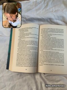 an open book sitting on top of a bed