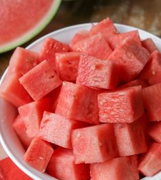 a white bowl filled with watermelon slices