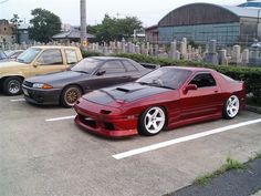 two cars parked in a parking lot next to each other