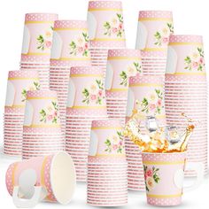 a bunch of pink cups with flowers on them