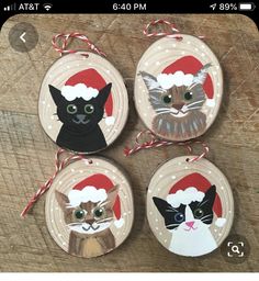 four ornaments with cats wearing santa hats on them