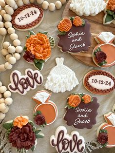 decorated cookies are arranged on a platter with the names of their guests and date