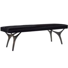 a black bench sitting on top of a metal frame legs and seat cushioned to it's sides