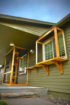 a house with a bird cage on the front porch and stairs leading up to it