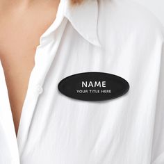 a woman wearing a white shirt with a name tag on it