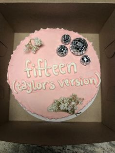 a cake in a box with the words fifteen taylor's version written on it