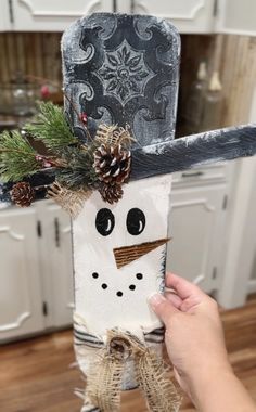 someone is holding up a paper bag with a snowman on it