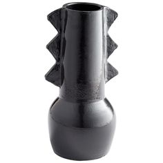 a black vase sitting on top of a white table