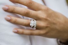 a woman's hand with two wedding rings on it