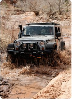 a jeep is driving through some muddy water