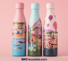 three different colored bottles with designs on them