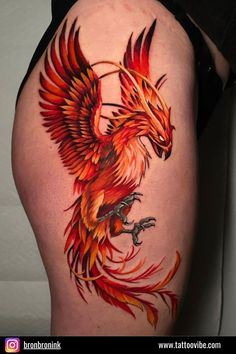 a woman's thigh with a red and orange bird on it