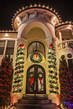 a house with christmas decorations and lights on the front door