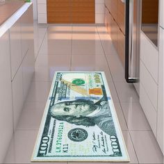 a dollar bill is on the kitchen floor next to an oven and countertop area