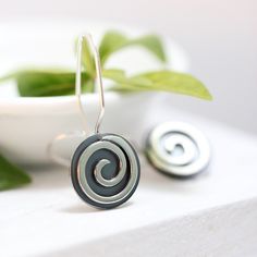 "These earrings are part of my spiral series. They are handcrafted of sterling silver with sturdy 19 gauge ear wires that clip securely in the back. They measure 5/8\" in diameter and about 1 1/8\" in length, and have a bright, shiny finish. I will ship these earrings via USPS First Class Mail within 3-5 days of receipt of payment." Handmade Swirl Earrings As Gift, Handmade Swirl Earrings For Gifts, Spiral Earrings With Ear Wire As Gift, Spiral Earrings With Ear Wire For Gifts, Unique Spiral Ear Wire Earrings, Unique Swirl Earrings As Gift, Unique Swirl Earrings For Gifts, Spiral Single Earring Gift, Spiral Single Earring As Gift