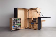 an open wooden cabinet with drawers and shelves