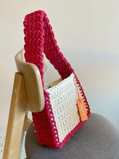 a crocheted purse sitting on top of a chair