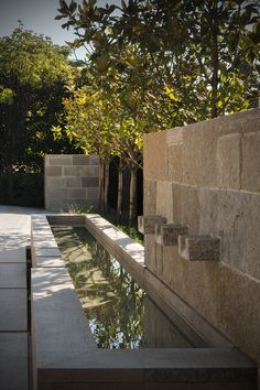 an outdoor water feature with trees in the background