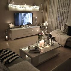 a living room filled with furniture and candles