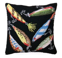 a black pillow with colorful fish on it