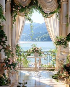 an outdoor wedding venue with flowers and greenery on the windowsill, overlooking water