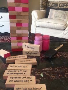 some pink and brown blocks sitting on top of a table next to a white chair