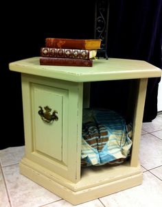 a small table with a lamp and books on it