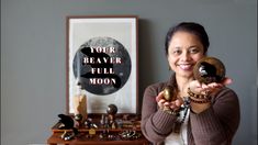 a woman holding up two rings in front of her face with the words your beaver full moon on it