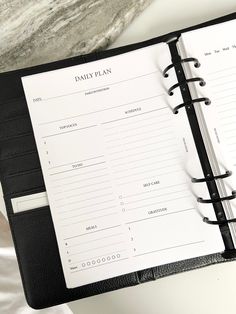 a black and white planner sitting on top of a table