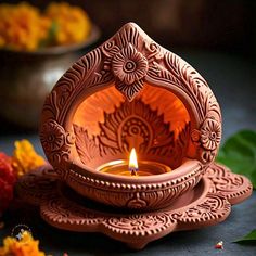 a lit candle sitting on top of a plate next to flowers and leaves in the background