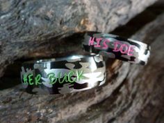 two wedding bands with the words his and her written on them in green ink, sitting next to each other