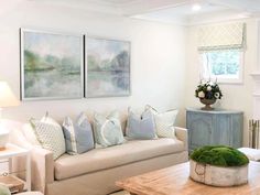 a living room filled with furniture and a painting on the wall above it's fireplace