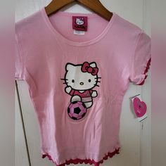 Nwt Sanrio Kid's Hello Kitty Pink Soccer Short Sleeve Shirt Sz 6; Hello Kitty Graphic With Bubble Soccer Ball; Fushia Pink Short Sleeve Shirt With Red Ruffle Embellishment; Scoop Neck; A Classic Character! 100% Cotton K01 Fitted Short Sleeve T-shirt For Playwear, Pink Cotton Hello Kitty T-shirt, Pink Hello Kitty T-shirt For Spring, Cute Fitted Tops With Cartoon Print, Playful Hello Kitty T-shirt For Spring, Fitted Pink Tops With Cartoon Print, Hello Kitty Crew Neck Top, Pink Hello Kitty T-shirt For Summer, Pink Hello Kitty Cotton Top