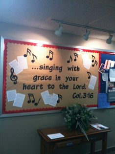 a bulletin board with sheet music notes on it in the corner of a classroom room