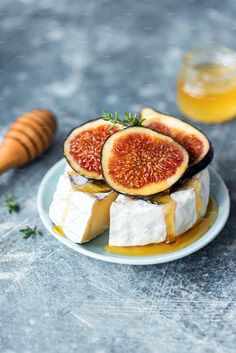 figs and cheese stacked on top of each other, with honey in the background