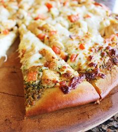 a pizza sitting on top of a wooden cutting board