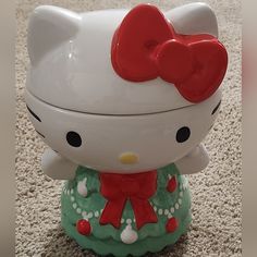 a hello kitty cookie jar sitting on the floor