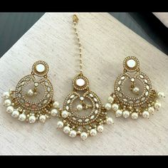 This A Beautiful And Elegant Mirror/Gold/Pearl Earrings And Matching Maang Tihka. Brand New Festive Pearl Earrings, Festive Pearl Drop Earrings, Elegant White Pearl Chandbalis, Pearl Earrings With Stone Work For Wedding, Wedding Pearl Earrings With Stone Work, White Kundan Earrings With Pearl Chain, Bollywood White Pearl Chain Earrings, White Bollywood Earrings With Pearl Chain, Elegant Bridal Earrings With Stone Work And Pearl