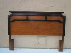 the headboard is made from wood and has an iron bar at the foot board